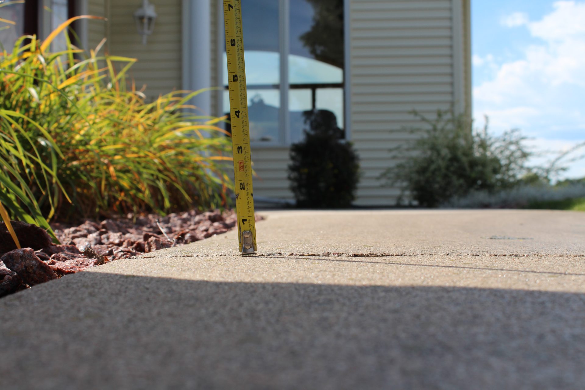 Walkway slab leveled with foam lifting — trip hazard eliminated